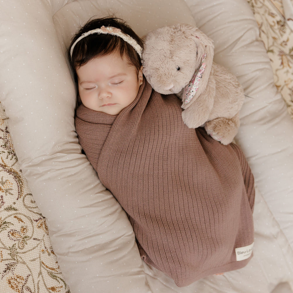 Organic ribbed knit cotton baby blanket in soft, soothing colors for cozy comfort and warmth. Perfect for infants.