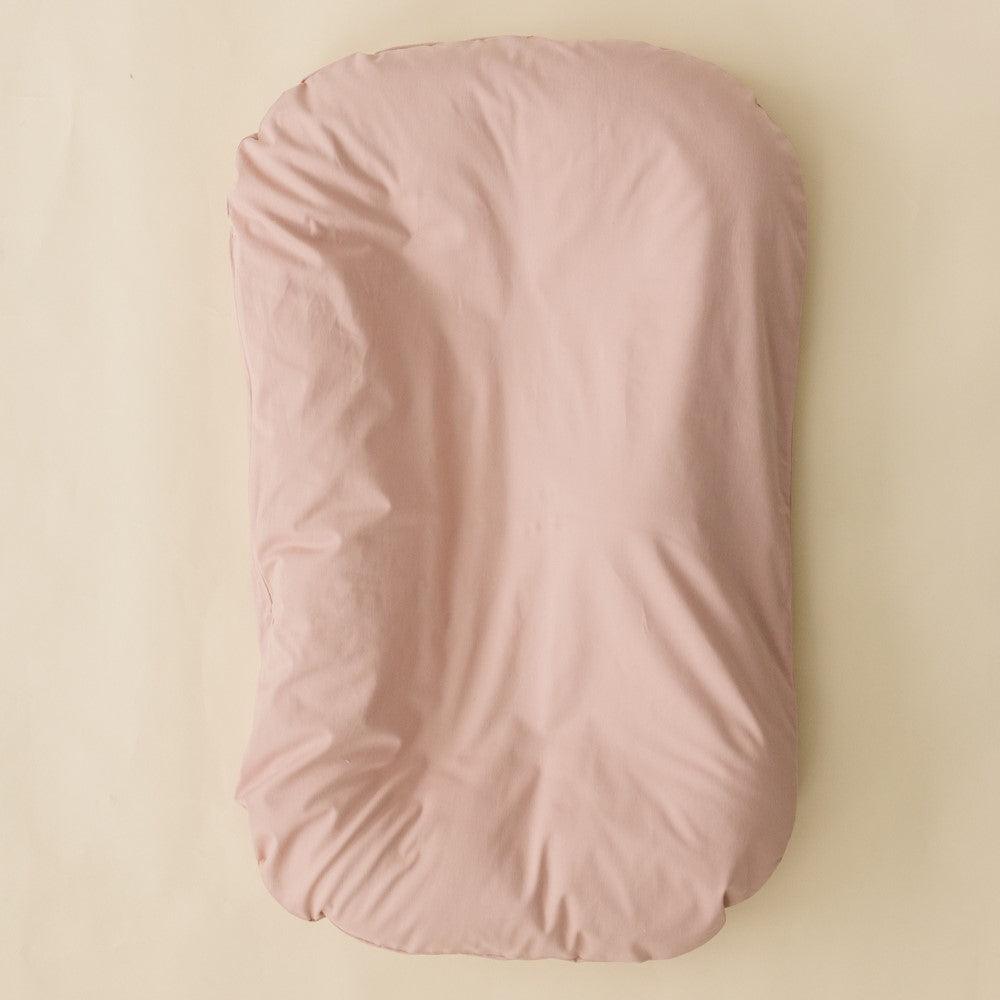Blush infant lounger cover for babies, perfect accessory for comfort and style.