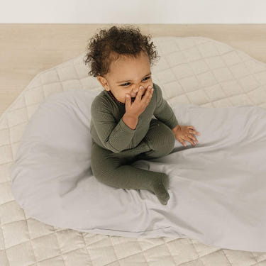 Stone infant lounger cover for cozy and stylish baby comfort. Perfect accessory for your little one's lounging needs.