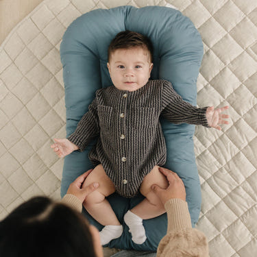 Infant Lounger Pillow in Bluejay - Comfortable travel essential for babies, perfect for lounging and support.