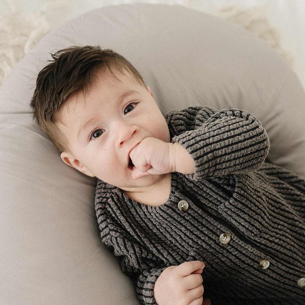 Stone nursing pillow for comfortable breastfeeding support, designed for moms and babies.
