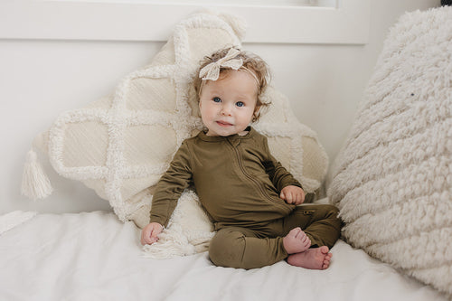 Solid Bamboo Zippy Pajamas in various colors, angle view 4, perfect for cozy baby sleepwear.