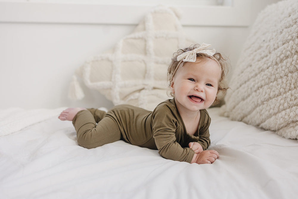 Solid Bamboo Zippy Pajamas in various colors for babies - soft, stylish, and perfect for comfort.