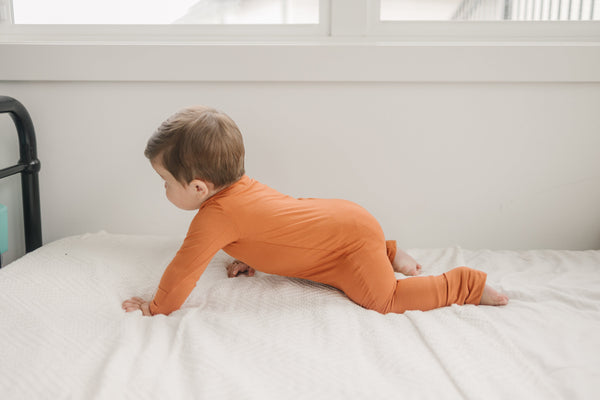 Solid Bamboo Zippy Pajamas in various colors, angle 3 view, perfect for baby comfort and style.