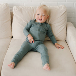 Solid Bamboo Zippy Pajamas in various colors for babies - soft, stylish, and perfect for comfort.