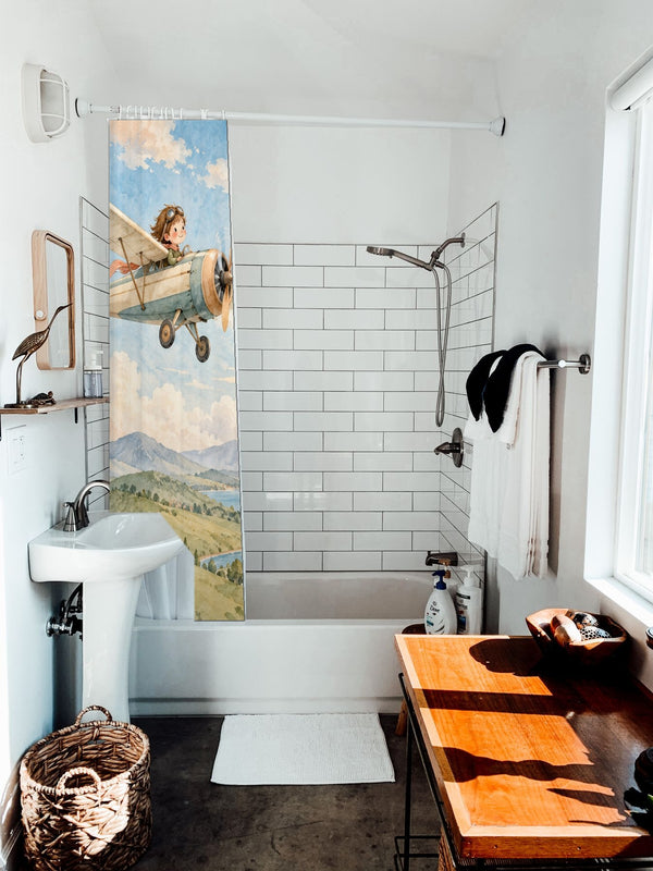 Vintage Airplane shower curtain hanging on the rod over a white bathtub