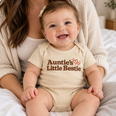 Baby wearing the Auntie's Little Bestie baby bodysuit