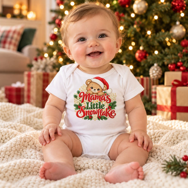 Child wearing the Mama's Little Snowflake baby bodysuit at Christmas