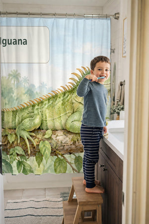 Child brushing teeth in a family bathroom with the I is for Iguana Alphabet shower curtain