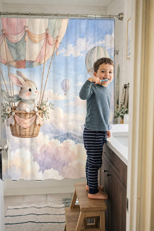 Child brushing teeth in a family bathroom with the Bunny Hot Air Balloon shower curtain