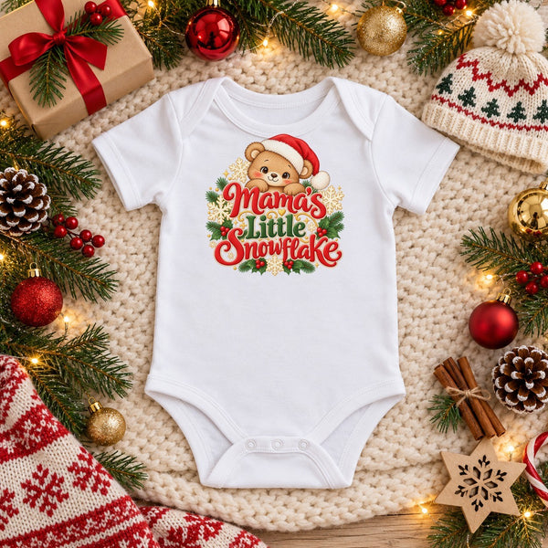 Mama's Little Snowflake organic cotton baby bodysuit in white, Christmas flat lay