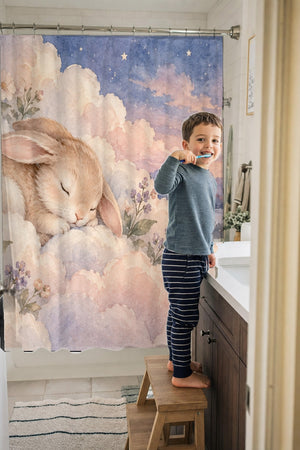Child brushing teeth in a family bathroom with the Cloud Bunny shower curtain