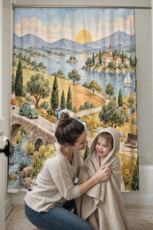 Mom drying her toddler in a hooded towel in front of the Vehicle Parade shower curtain