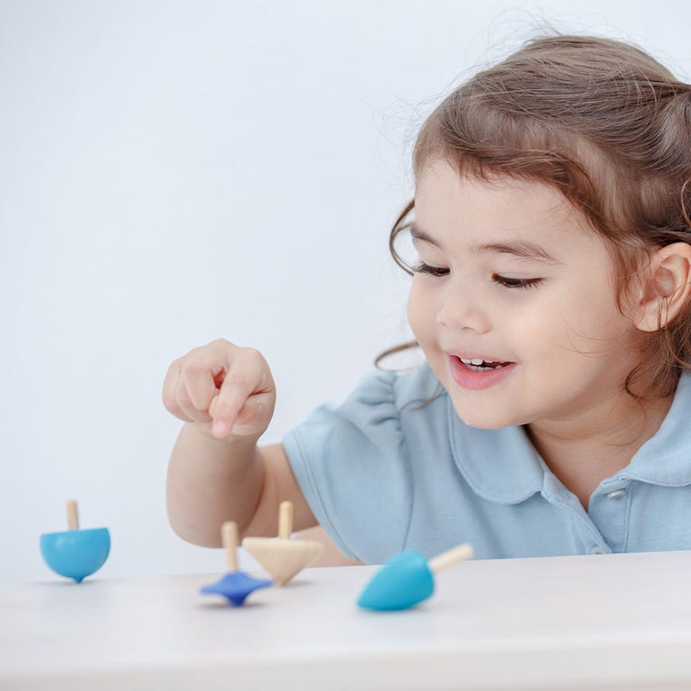 Colorful mini spinning tops for babies, perfect for playtime and developing motor skills.