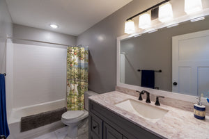 Peaceful Farm shower curtain pulled open in a gray kids bathroom