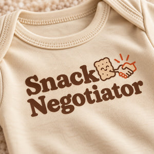 Close-up of the Snack Negotiator baby bodysuit print