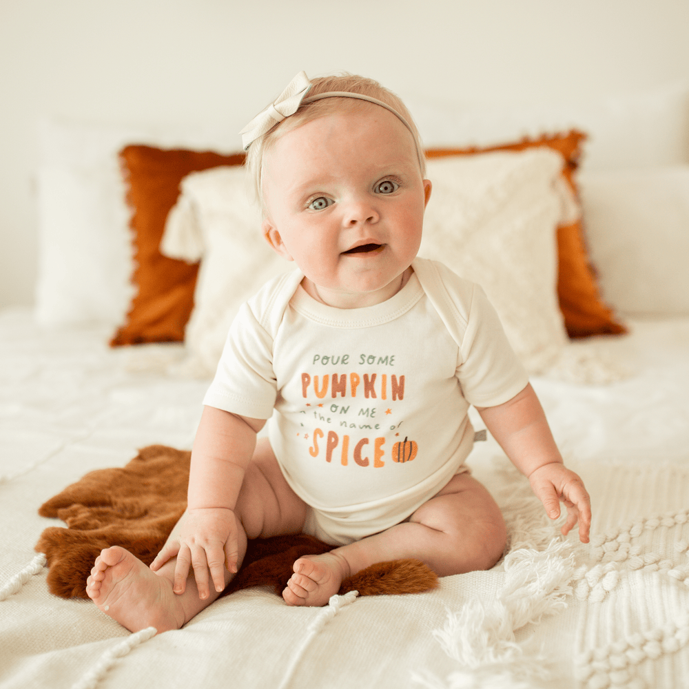 "Graphic short sleeve bodysuit for babies featuring 'Pour Some Pumpkin' design."