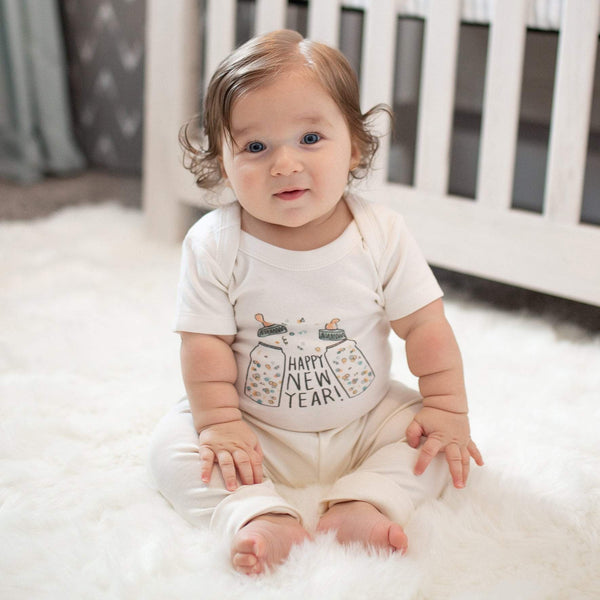 Graphic bodysuit "Poppin Bottles" in angle view, perfect short sleeve onesie for stylish babies.