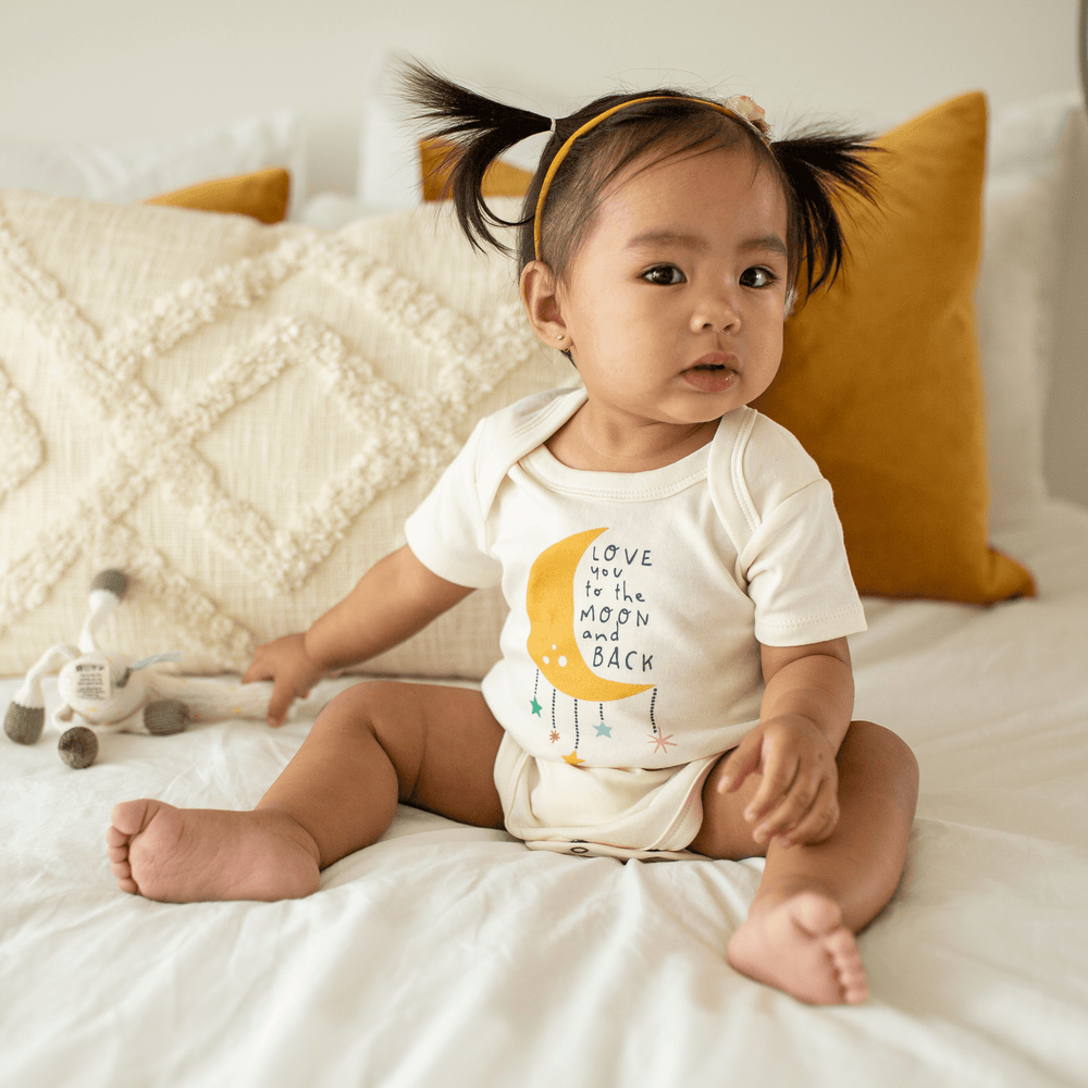 Graphic short sleeve bodysuit for babies featuring a moon and back design. Perfect for comfort and style.