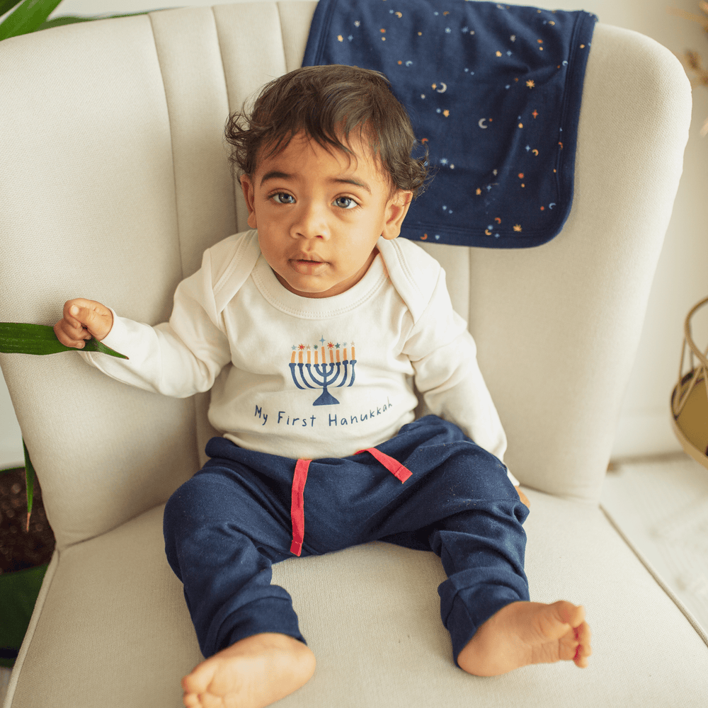 Long sleeve graphic bodysuit for babies featuring "My First Hanukkah" design. Perfect for celebrating the holiday!