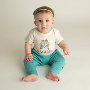 "Graphic short sleeve bodysuit for babies featuring 'Beach Bum' design, angle view showcasing style and comfort."