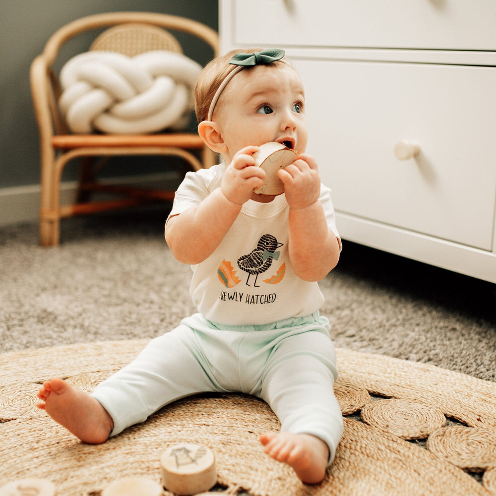 Newly hatched graphic bodysuit for babies - short sleeve onesie in soft fabric. Perfect for comfort and style.