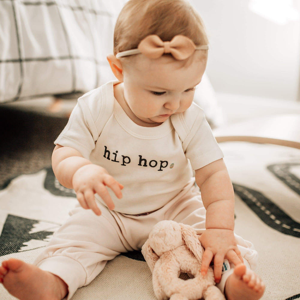 Hip hop graphic bodysuit for babies, short sleeve, stylish and comfortable for trendy little ones.