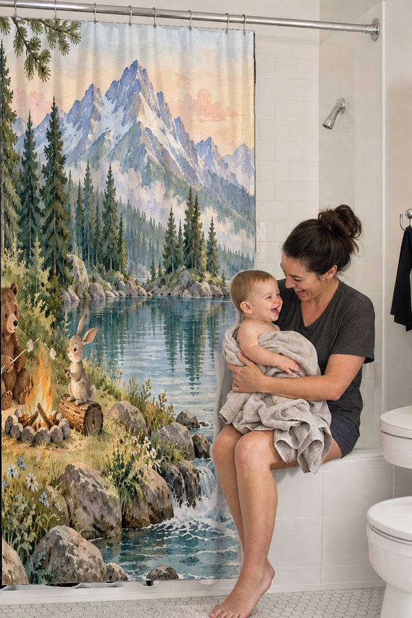 Mom holding her baby on the tub edge next to the Woodland Adventure Camping shower curtain