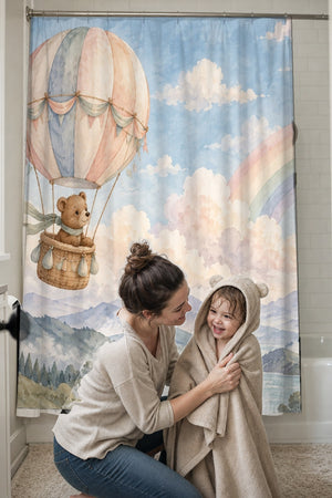 Mom drying her toddler in a hooded towel in front of the Bear Hot Air Balloon shower curtain