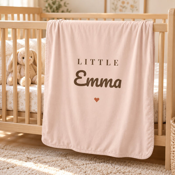 Little Name swaddle blanket in blush, styled photo 1