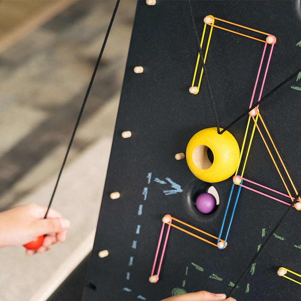 "Colorful wall ball game for babies, promoting active play and development in a stylish furniture design."