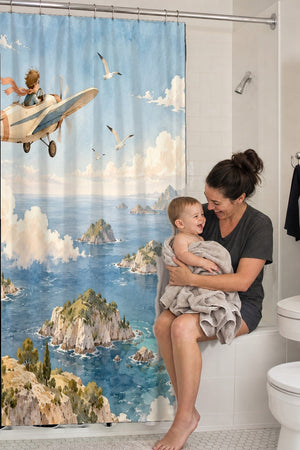 Mom holding her baby on the tub edge next to the Coastal Explorer shower curtain