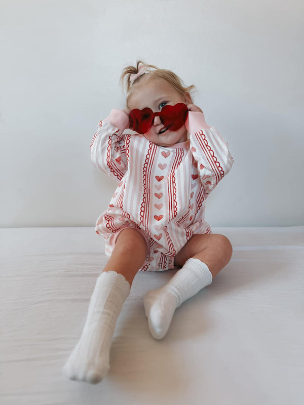Laced with Love Sweatshirt Romper for babies, stylish and cozy, shown from angle 3. Perfect for playful outings!