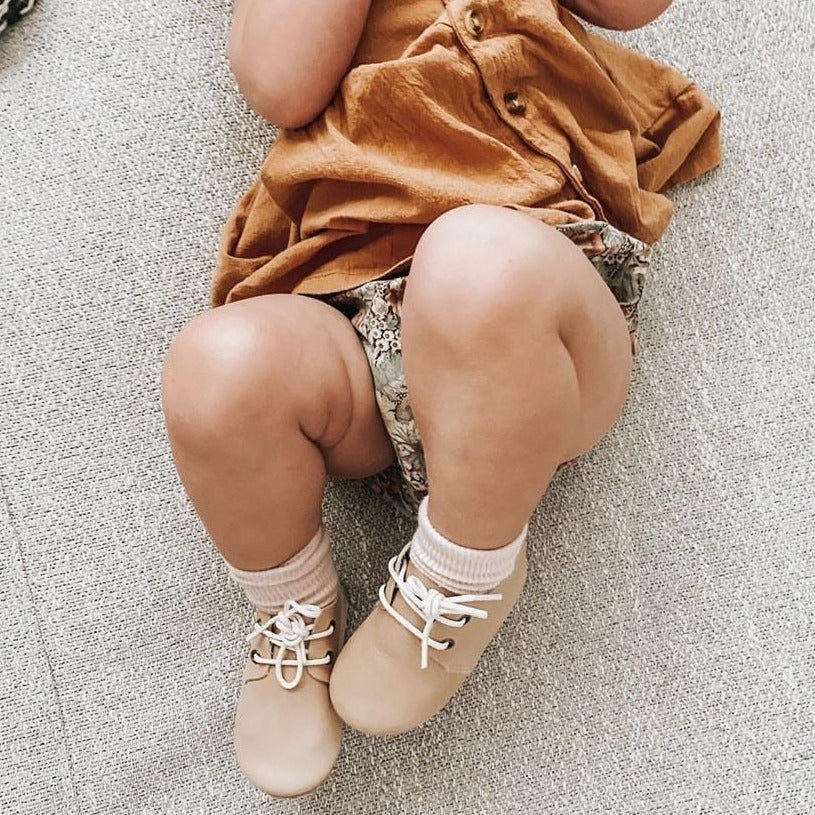 Tan low top oxfords for babies with hard sole, perfect for stylish and comfortable first steps.