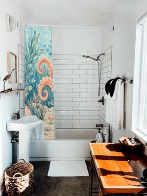 Friendly Octopus Ocean shower curtain hanging on the rod over a white bathtub