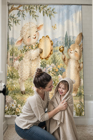 Mom drying her toddler in a hooded towel in front of the Lamb and Bunny Music shower curtain