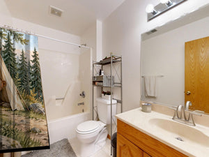 Bear Tent Sunrise Camping shower curtain on a tub shower combo in an American family bathroom
