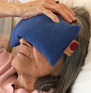 Cherry Ice® Blue Denim Eye Pillow in zip-close freezer bag, angled view showcasing design and packaging.