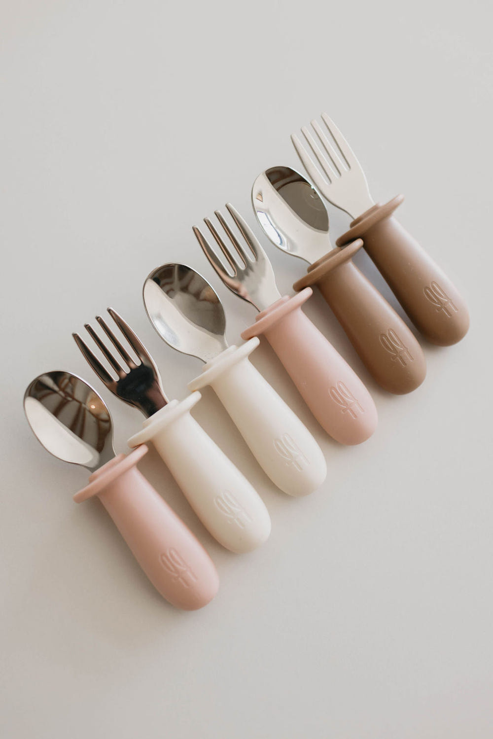 Colorful baby training utensil set for easy self-feeding, including spoon and fork, perfect for little hands.