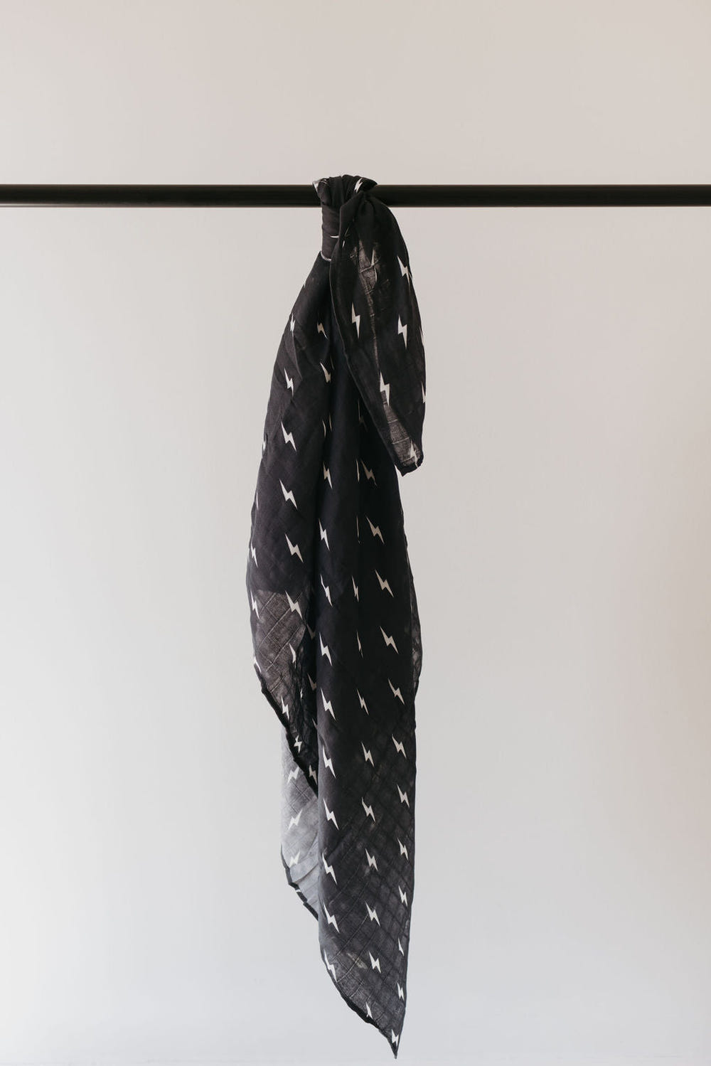 Muslin swaddle featuring a midnight lightning bolt design, perfect for wrapping your baby in comfort and style.