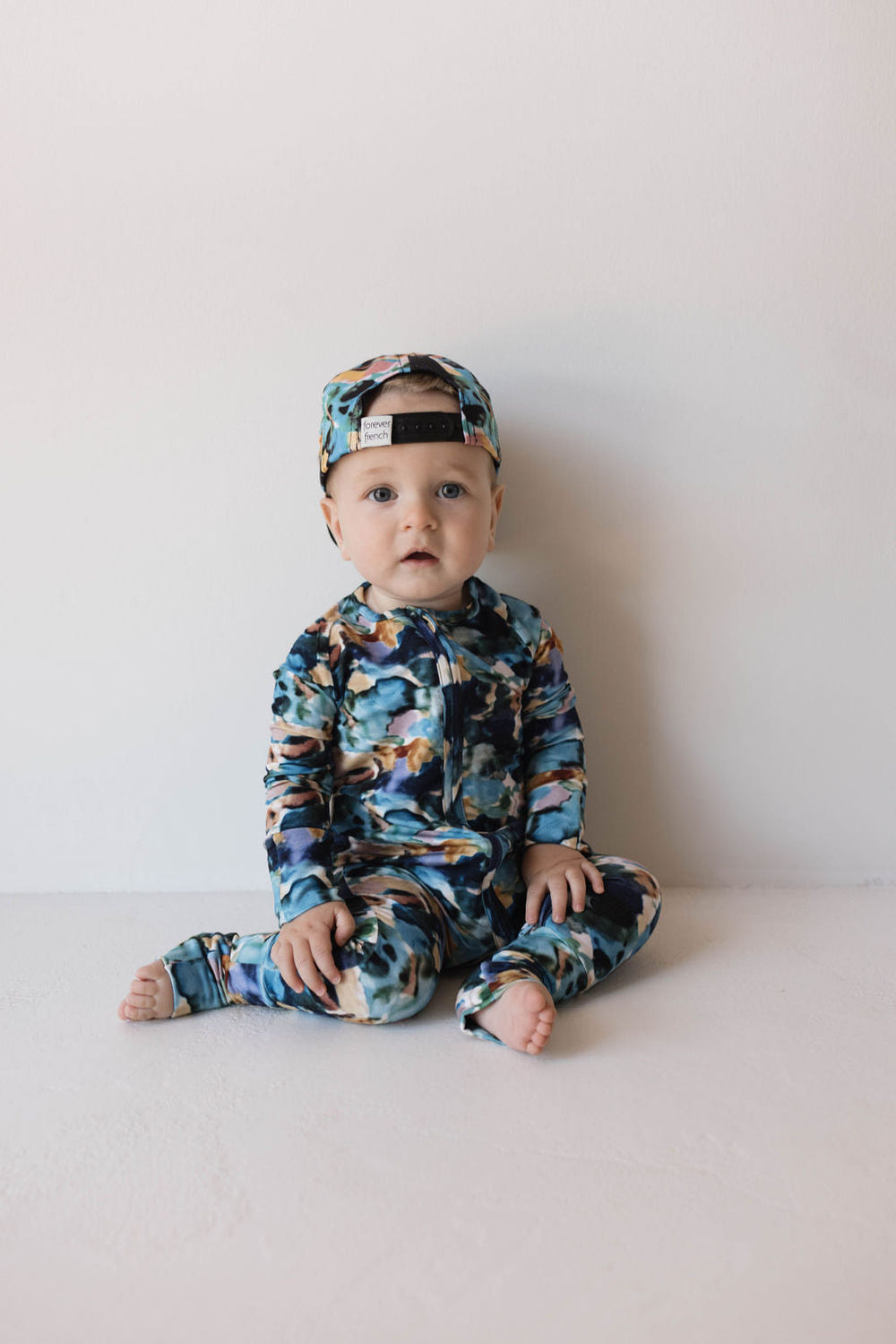 Bamboo zip pajamas in Charli print for babies, soft and stylish sleepwear for comfort and ease.