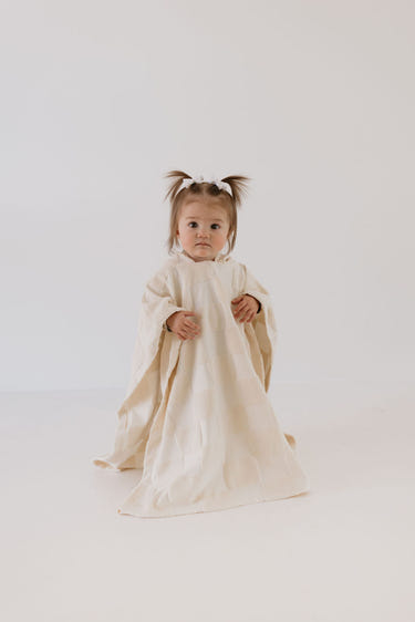 Cream checkerboard hooded towel for babies, soft and cozy for bath time.