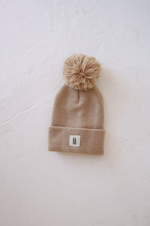 Taupe ff Knit Pom Top Beanie for babies, stylish and cozy, shown from angle 6.