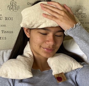Hot Cherry Eye Pillow in unbleached natural denim, pre-washed, angled view showcasing its soft texture and design.