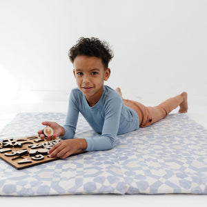 Blue tile vegan leather play mat at an angle, perfect for baby playtime and stylish nursery decor.