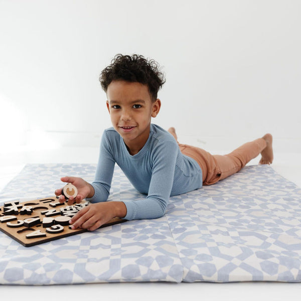Blue tile vegan leather play mat at angle 8, perfect for babies to play and explore safely.