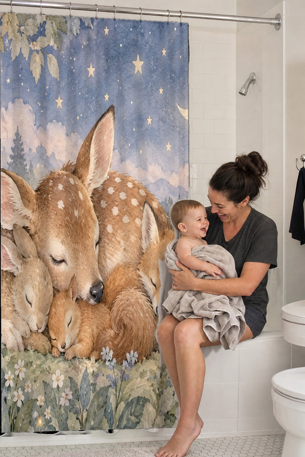 Mom holding her baby on the tub edge next to the Woodland Friends shower curtain