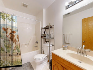 Farm Parade shower curtain on a tub shower combo in an American family bathroom