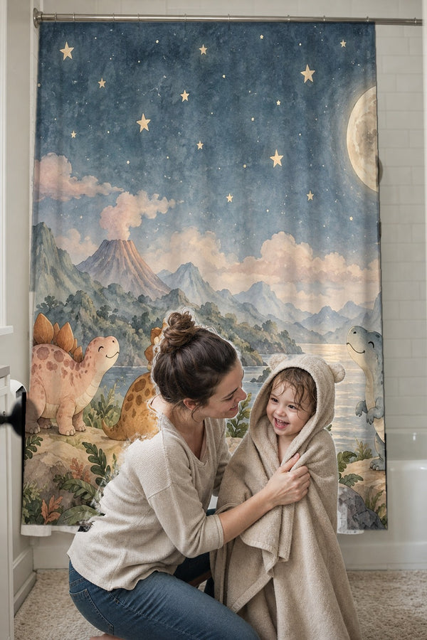Mom drying her toddler in a hooded towel in front of the Moonlit Dinosaurs shower curtain