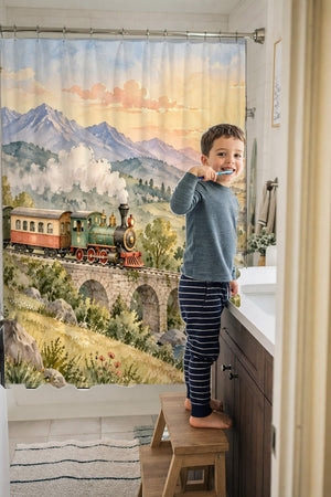 Child brushing teeth in a family bathroom with the Sunrise Train shower curtain